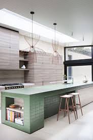 The vintage wood tone island add a farm look to this green kitchen. Tiled Kitchen Island In Contemporary Wood Kitchen At Layer House By Robson Rak Architects