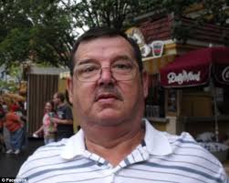 The coroner who swirled his finger in victim's gunshot was convicted for  blowing a woman's legs off with dynamite 30 years ago