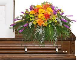 Celebrate the lives of loved ones with a feminine floral design to display pictures. Radiant Medley Casket Spray Funeral Flowers In Greenfield Ma Floral Affairs