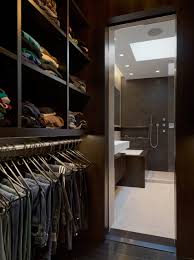 Wooden cabinets with mirrored and frosted glass doors surround a mobile seat over the beige carpet flooring. 75 Beautiful Small Men S Closet Pictures Ideas July 2021 Houzz