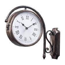 This beautiful clock with a scrolled wall mount is inspired by the antique clocks that hang in train stations. Sterling Home Bronze Metal Double Sided Train Station Wall Clock