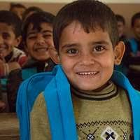 A former Iraqi insurgent gets his photo taken by a