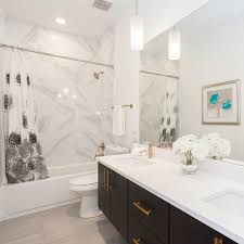 Black And Gold Marble Tiles Modern Bathroom With Grey Tile Floor Marble Tile Pendant Lighting Black Vanity With Gold Hardwar Apartment Bathroom Bathroom Pendant Lighting Bathroom Decor