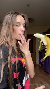 Gloria sol sucks on banana
