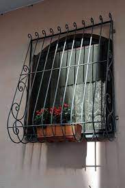 Window With Grille Flowers And Curtain Procida Na Home Window Grill Design Balcony Grill Design Window Grill Design