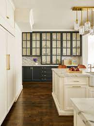 Pretty Transitional Farmhouse Kitchen With A Wall Of Glass Cupboards Designed By Carrie H Built In China Cabinet Built In Kitchen Cupboards Transitional House
