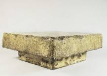 It's recessed into a lower part of light beige coarse stone. Stone Coffee Tables With Modern Style