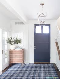 A creamy yellow rug looks fresh and homey in front of the kitchen sink. Bright Entryway With Blue Plaid Rug Room For Tuesday