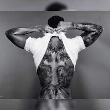Black and blue cross back tattoo. Lewis Hamilton S Back Tattoo Of A Cross And Angel Wings