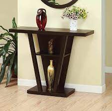 The angular base can be used to store books or even showcase wine bottles in a original way. Featherston Console Table Console Table Decorating Corner Table Designs Console Table
