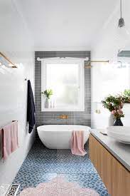 Look through grey and white bathroom. Gray Subway Tiling In A Serene Pink White Bathroom