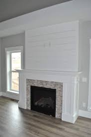 white shiplap fireplace with perfectly placed outlets for mounting your tv c m home builders farm house living room fireplace remodel farmhouse fireplace