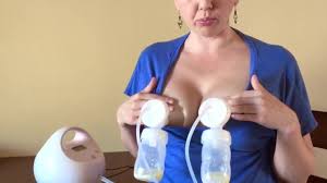 Homely MILF shows how to pump milk out of both tits