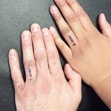 20+ tiny finger tattoos with big senses of style. 16 Wedding Ring Tattoos We Kind Of Love Finger Tattoos For Couples Couple Tattoos Unique Wedding Band Tattoo