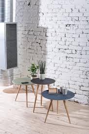 A glamorous yet masculine square coffee table, crafted by hand, with an angular solid brass colored frame and a padded, deep buttoned top upholstered in lustruous aged hazelnut leather. Arp Elegant And Contemporary Side Table By Gazzda