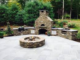 Let us help you design & build your dream outdoor kitchen and create your backyard oasis Outdoor Kitchen With Pizza Oven Fire Pit Smoker And Rotisserie Fire Pit Backyard Backyard Fire Backyard Fireplace