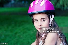 Girl On Bike With Helmet And Braces High-Res Stock Photo