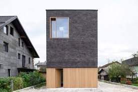 A house with brick veneer isn't supported by the bricks — instead, the house's inner walls bear the structure's weight. Arhitektura Completes The Double Brick House On A Six Metre Wide Plot