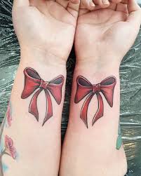 The tattoo depicts a neat bow tied slightly above the wrist. Awesome Red Bow Tattoo On Both Wrist Parryz Com