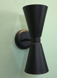 Check out our mid century lighting selection for the very best in unique or custom, handmade pieces from our chandeliers & pendant lights shops. Exterior Dual Cone Bowtie Wall Sconce By Practical Props