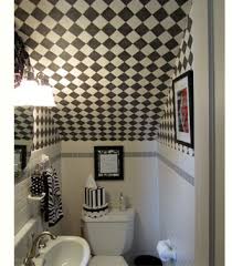 Hidden powder room under the stairs is filled with a wood and marble washstand under a carved wood mirror lining a wall clad in cream floral wallpaper. Bathroom Ideas Under Stairs Room Pictures All About Home Design Furniture