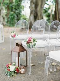 Clear Acrylic Ghost Chairs Decorated With Hand Painted Names To Reserve Seats For Wedding Ceremony In 2020 Ceremony Chairs Ghost Chair Wedding Florida Wedding Ceremony