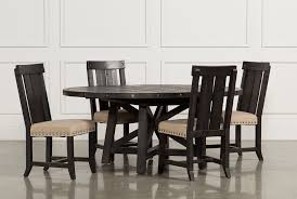 This round table sports a rich hazelnut stain to showcase the wood's grain, small knots, and joint lines for an authentic aesthetic. Jaxon 5 Piece Extension Round Dining Set With Wood Chairs Living Spaces