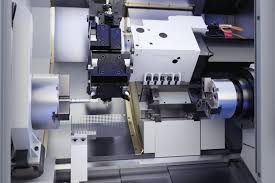 현대적인 디자인의 CNC 터닝 센터가 공장에 설치된 전경, 칩 컨베이어와 컨트롤러가 결합된 모습