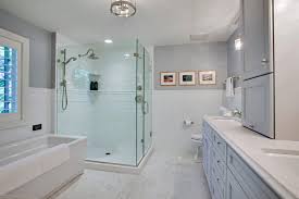 A very light marble countertop contrasts with a gray patterned wallpaper in this bathroom by cory connor designs. Light Gray And White Steal The Show In A Master Bathroom Remodel Dura Supreme Cabinetry