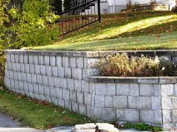 Whether used for an outdoor garden wall or as an interior basement wall, paint provides one answer for dressing up the boring gray blocks. How To Build A Retaining Wall From Concrete Blocks