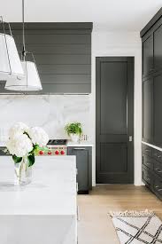 Brass pulls complement white kitchen cabinets topped with a white and gray quartz countertop, as rustic wood floating shelves are mounted against a vertical shiplap trim and beside white upper cabinets. Pin On Painting Walls Furniture Cabinets With No Sanding Just Painting Easy