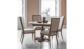 It includes a rectangular dining table, two dining chairs with arms, and four armless dining chairs. Mustique Round Extendable Table Crinions Furniture