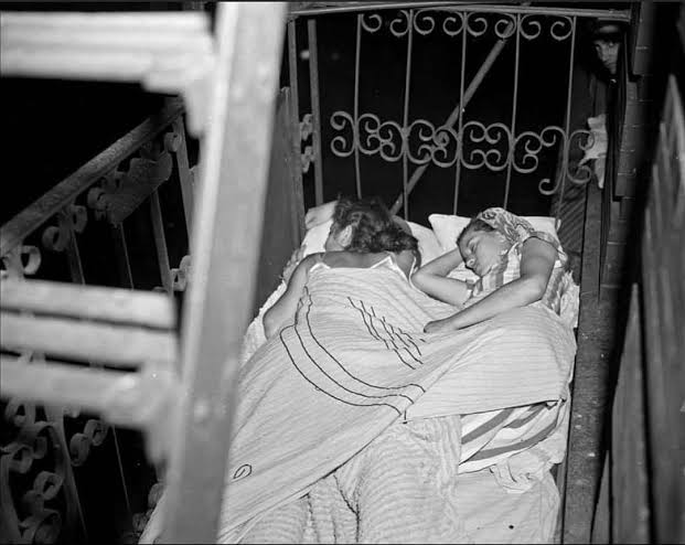 Two women napping on a E 11th St. fire escape to catch a cool breeze on  Aug. 30, 1948. : r/HistoricalCapsule