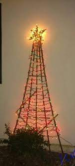Ideas for decorating metal trellis for christmas holidays. Christmas Tree Made Out Of A Garden Trellis Turnred Upside Down A Homemade Star And Some Lights Yard Christmas Christmas Trimmings Photo Tree Garden Trellis