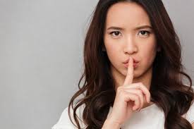 You'll find true black in the hair dye aisles of drugstores, and on celebs like katy perry and megan fox. Premium Photo Portrait Of Beautiful Asian Woman With Brown Hair Holding Index Finger On Lips Asking To Keep Silence Over Gray Wall