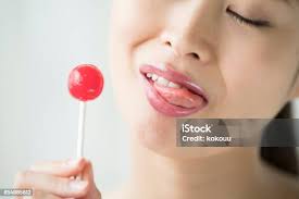 Woman Licking Sweet Sugar Candy Stock Photo