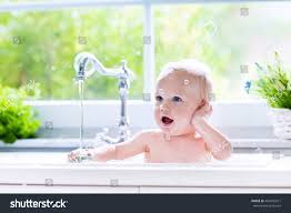 baby taking bath kitchen sink child