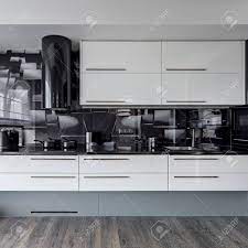 Check spelling or type a new query. Modern Kitchen With White Cupboards And Black Wall Tiles Stock Photo Picture And Royalty Free Image Image 105231120