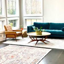 Sunny Great Room With Article Ocean Blue Sofa Brown Leather Chair Vintage Coffee Table Ell Brown Living Room Brown And Blue Living Room Trendy Living Rooms