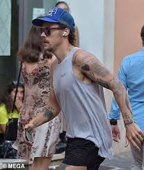 With his new mustache on full display. Harry Styles Debuts A Very Different Look As He Sports A Moustache While Out Jogging Through Rome Daily Mail Online
