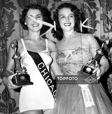 Neva Jane Langley (left) and Jo Hoppe (right) holding up their trophies,  which they won competing