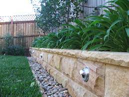 The landscaped garden constructs retaining walls from a. What You Need To Build A Sandstone Garden Wall