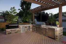 stone outdoor kitchen with grill and