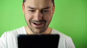 young man using tablet green screen background