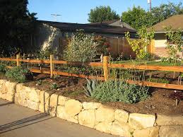 Handmade log fence in a jagged pattern lines the forrest as autumn leaves create a blanket of brilliant colors on the ground. Split Rail Fences Archives Fence Factory