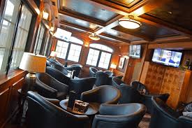 Muted colors on the walls, some squishy leather furniture, and a little lower level of lighting than a typical storefront goes a long way towards making the guest feel like he's walked into somewhere they can sit and rest for a. Hill Harbor Cigar Lounge