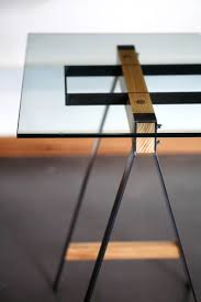 The Glass Trestle Table Explores The Relationship Between Steel And Wood To Complement Each Other In A Furniture Design Modern Glass Furniture Steel Furniture
