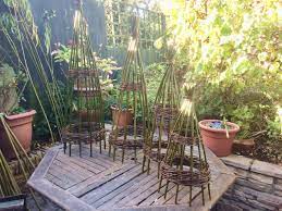 High quality garden arches and obelisks made from wood, metal and willow in a variety of styles to provide stylish plant support for roses and other climbing plants in the garden. Willow Obelisks