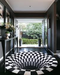 Black And White Illusion Rug Down The Rabbit Hole Our Ever Popular Black Hole Rug By Daniel Malik Creates A Totally Unique Entrance To This Home By Seagar Des Cool Rugs Rug Design Design