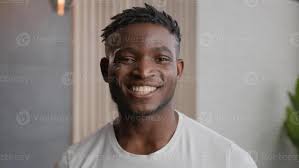 African American man brushing teeth and scrolling mobile phone in home  bathroom busy time management ethnic male oral care morning hygiene shocked guy  read amazing news